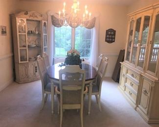 Dining room set includes a table with 6 chairs and china cabinet. The table has 2 large leaves and table pads. The other china cabinet does not match exactly.