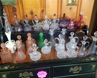 Beautiful cut glass cruets, various colors, many matched sets.