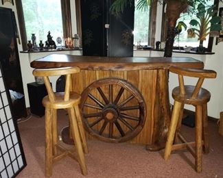 Man Cave-o-Rama Bar!!! You don't see many of there. Hand hewn with wagon wheel on front and matching bar stools. While you are at it, get the palm tree and tropical elements to boot! 68" x 38" x 22" Palm tree over 7" with fronds