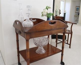 Drop leaf rolling serving cart with drawers.