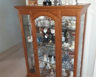 Curio cabinet full of art glass, willow tree, snow bunnies, Waterford, Royal Doulton and Lenox