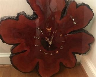 Clock made from tree slice with Coast Guard ranks as hour markers.  