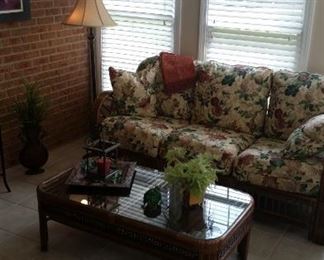 Benchcraft 3-cushion sofa, Benchcraft rattan coffee table with glass table topper, floor lamp with double chain pulls, metal tray, Southern Living at Home candle lantern with glass pillar, beaded turtle, SLaH metal planter with floral, new with tags throw