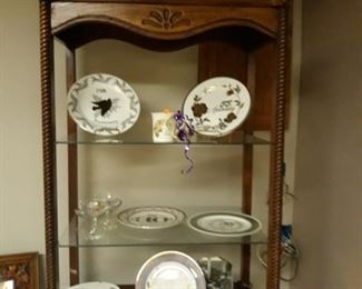 Anniversary plates and lighted shelving unit.