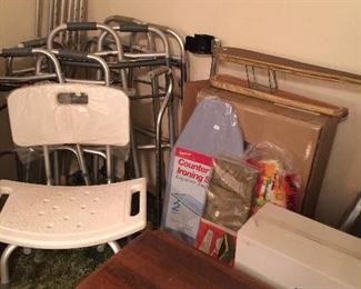 Many walkers, shower chair, laundry items,