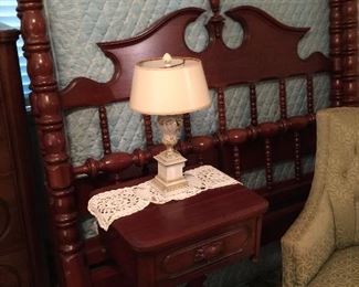 Full size bed with rails, side table.