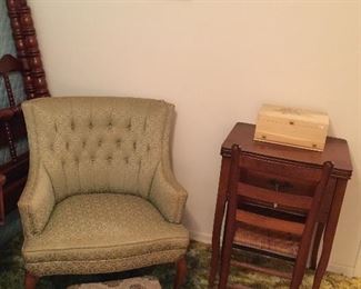 Empty sewing cabinet, arm chair, small stool.
