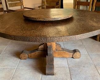 6ft dia Rustic Hammered Dining room table w/ 8 Chairs & lazy boy	61in diameter x 30in H 	(This was a $14,000.00 table .. Great condition. Comes with 8 chairs, 4 of them being captain chars..  Matched lazy susan.)