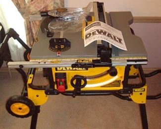 Dining Room: This DeWALT Heavy Duty 10" Job Site Table Saw with stand (DWE7491) was just purchased in February and never used! The manual comes with it.