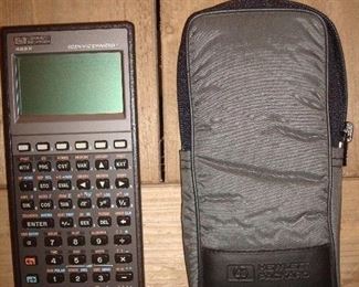 Living Room: A hand-held HEWLETT-PACKARD 48-SX scientific expandable calculator comes with its original case and manuals.
