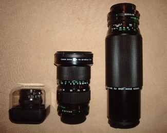 Living Room: Three camera lenses: EL-Nikkor 1:2.8 f=50mm; CANON zoom lens FD35-105mm (5-l/2" long); and a CANON zoom lens FD100-300mm (9-l/4" long).