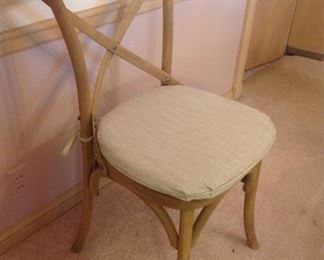 Dining Room:  This is one of the six armless weathered oak RESTORATION HARDWARE "Madelaine" French bistro style chairs that surround the reclaimed oak table.  They are rustic with woven cane seats [as shown in the next photo] and a stylish "X" back.  The set of 6 chairs is priced separately from the table.   Each chair currently has a neutral seat cushion which is priced separately in a set of six.