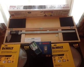 Dining Room: Five items are shown. From top to bottom: 1) a NEW MAASDAM-Power-Pull 3/4 ton-22" cable reach in its box; 2) a FOWLER Digital Electronic Caliper-24"/Power SR44 in its wooden case; 3) a BOSCH - LR1G Green Rotary Laser
Receiver (includes original box); and 4) & 5) two brand-new DeWalt 10' - 80 teeth DW7667 circular saw blades (each is priced individually).