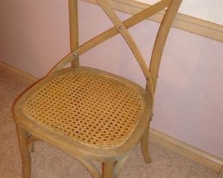 Dining Room: The chair pad has been removed to reveal the cane seat of one of the six weathered oak RESTORATION HARDWARE "Madeleine" French bistro chairs.