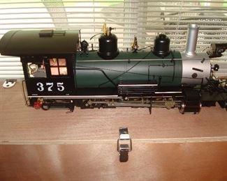 Living Room: The ACCUCRAFT D&RGW Engine is 22" long and coal fired with a boiler as shown in the next photo. Manuals are included for its operation. It comes with the original wooden box that is shown. It is 1:20.3 scale, 45m gauge. ALL of these train are in pristine condition--never used!