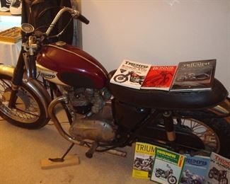 Living Room: This is another view of the classic 1967 TRIUMPH Bonneville. Books on Triumphs were gathered and displayed with the bike.