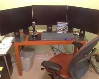 Bedroom #1: Three 27" DELL monitors, a thrust master hotas wart hog replica USAF A-18c flight simulator stick (joy stick); a GF-SECM Flight simulator; a "MicroSoft Flight Simulator for Pilots Real World Training Book;" a pair of 8" tall BOSE speakers; computer table; and Steelcase office chair are shown.
