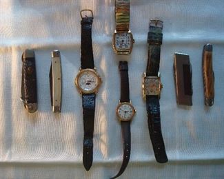 Living Room-Case: A blue vintage Cub Scout jack knife "Camillus;" pearl handle knife; CITIZEN watch; HAMILTON wind-up watch; TIMEX watch; BENRUS watch-no crystal; stainless/wood handle knife; and a horn handle knife.