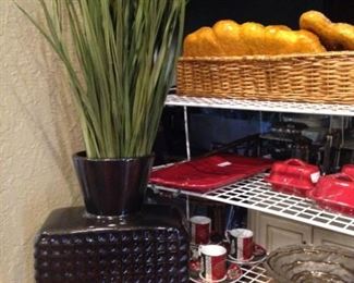 Rusty-red and black vase and greenery