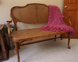 Antique caned settee