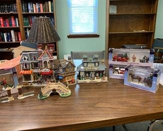 Over 30 lighted Christmas village buildings churches, shops, houses, trees, people, carriages, and snow.  