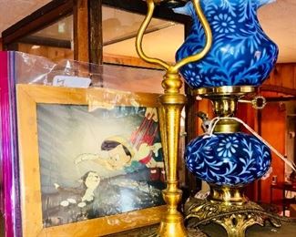 An amazing collection: Original Walt Disney Pinocchio celluloid movie cell, a Louis C. Tiffany Furnaces Inc. “Favrile” lamp, and a Fenton/L.G. Wright “Daisy & Fern” lamp.