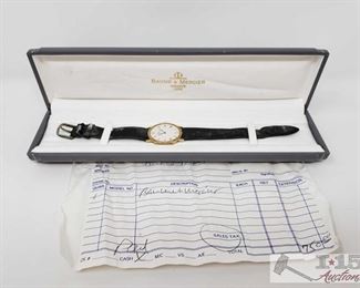 1562: 	
Baume & Mercier Watch with Case
14k Gold face, marked 95612 and 2214552, not ticking