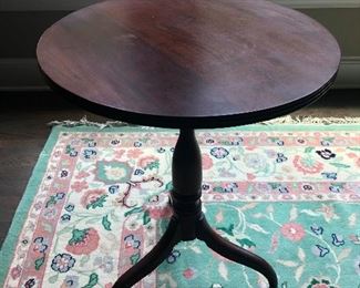 Round parlor table with an alien-talon for a base