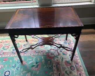 Burled wood end table wearing chastity belt.