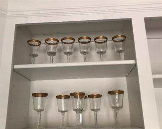 fancy gold-rimmed wine glasses, unlike the mayonnaise jar I'm drinking wine from right now