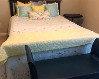comfy double bed with quilts and pillows.