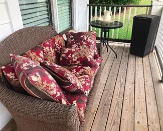 wicker sofa with pretty cushions