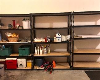 metal storage shelves in the garage with coolers and garage things