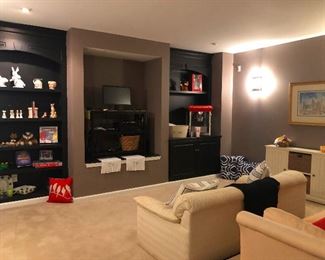 media room with white sofas. No buttered popcorn eating on those!