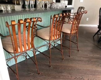 Curly copper-brushed bar stools for sitting in and kicking up your petticoats