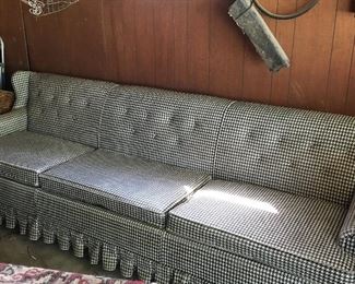 Vintage, extra long sofa with vinyl houndstooth upholstery.