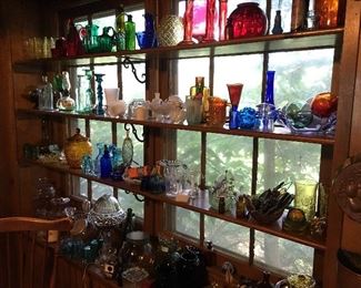 Various vintage and antique glass pieces including glass floats, a glass lamp, and more.