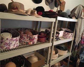 Hats of many shapes and sizes, original hat boxes, and wooden hat stands.