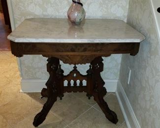 Antique foyer table with marble top and porcelain castors