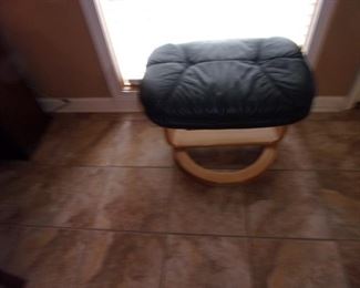 Mid Century Modern leather swivel chairs with ottomans.