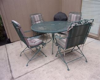 Wrought iron green patio table and four spring action chairs!