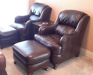 Two Flexsteel leather armchairs with nailhead trim and ottomans.