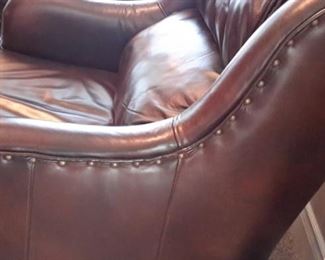 Two Flexsteel leather armchairs with nailhead trim and ottomans.