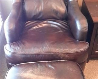 Two Flexsteel leather armchairs with nailhead trim and ottomans.