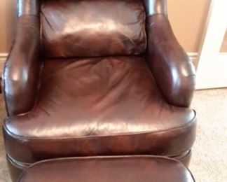 Two Flexsteel leather armchairs with nailhead trim and ottomans.