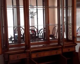 Benchmark lighted china cabinet. Matching dining room table and chairs.