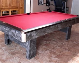 Contender by Brunswick in Graphite laminate/wood/metal with red felt includes pool table accessories such as cues.