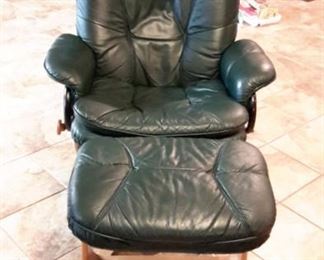 Mid Century Modern leather swivel chairs with ottomans.