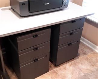 Commercial grade office desk and two heavy plastic filing systems.