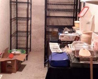 Four black metal shelves plus kitchen items.
